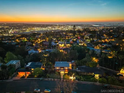 a view of front door of house with potted plants