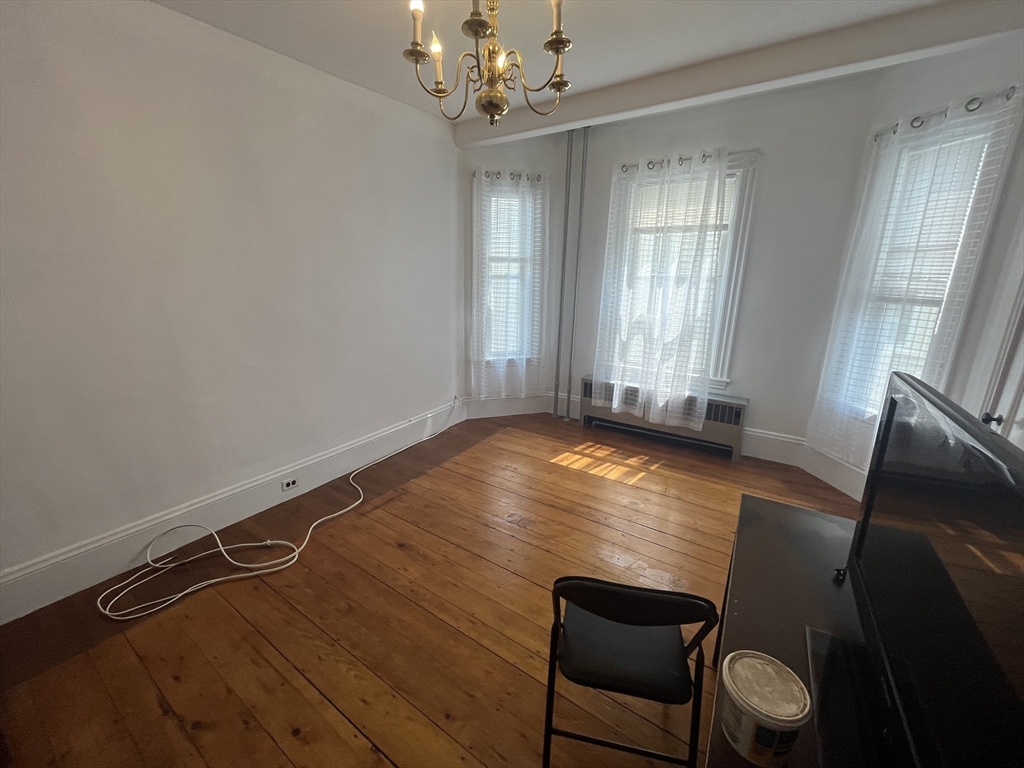 32 Howell Street, Unit 2 Boston, MA 02125 - Photo 14 of 24 a room with wooden floor and windows