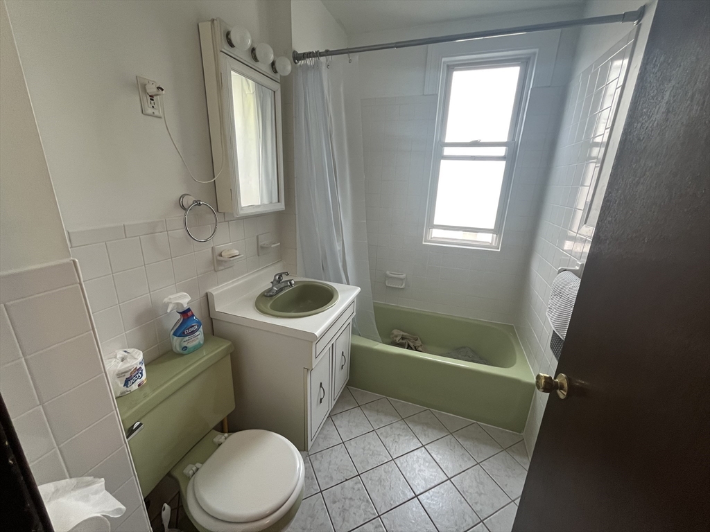 32 Howell Street, Unit 2 Boston, MA 02125 - Photo 16 of 24 a white toilet sitting next to a bath tub and a shower