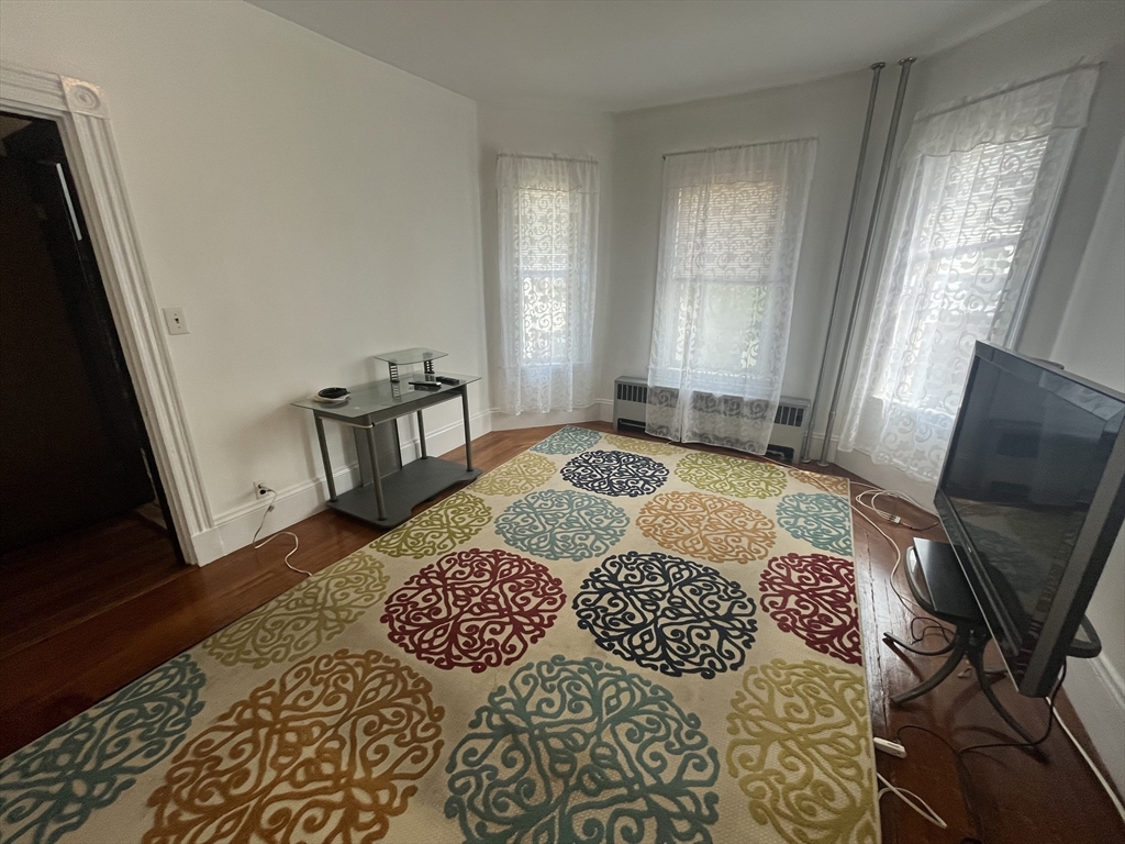 32 Howell Street, Unit 2 Boston, MA 02125 - Photo 7 of 24 a bedroom with a bed rug and a window