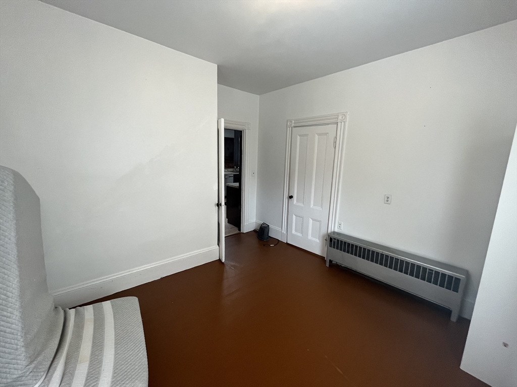 32 Howell Street, Unit 2 Boston, MA 02125 - Photo 10 of 24 an empty room with wooden floor