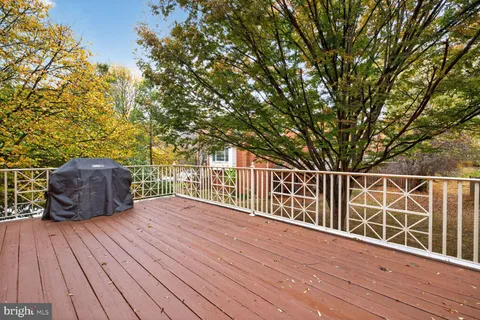a view of balcony with wooden floor and fence
