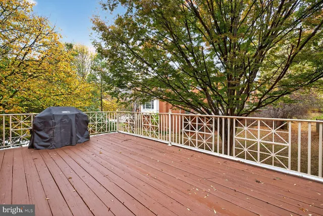 a view of balcony with wooden floor and fence
