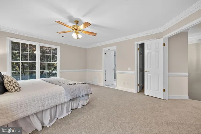 a bedroom with a bed and a large window