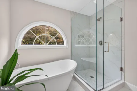 a bathroom with a glass shower door and a shower