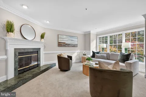 a living room with furniture a fireplace a window and a fireplace