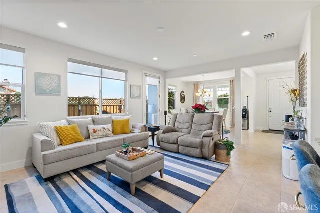 a living room with lots of furniture and kitchen view