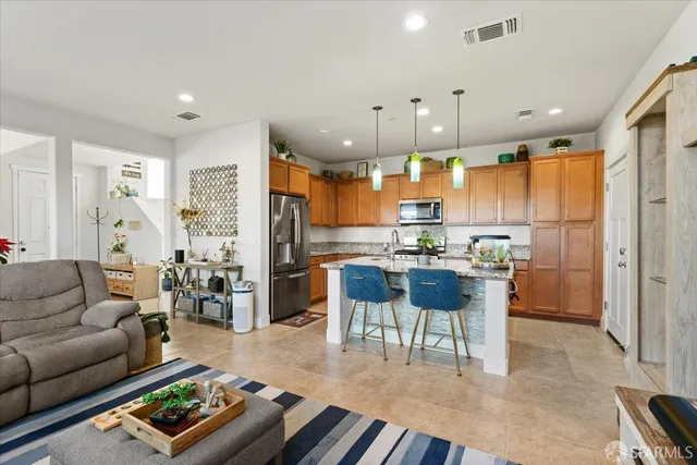 a bedroom with a large bed and a potted plant