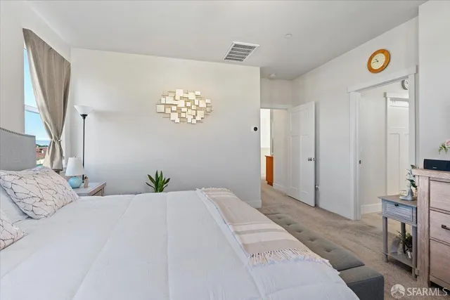 a bedroom with a bed and a mirror