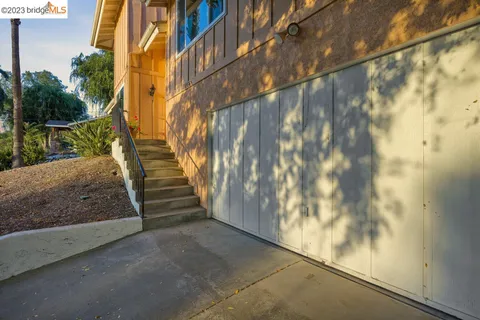 a living room with furniture a ceiling fan a wooden floor and a window