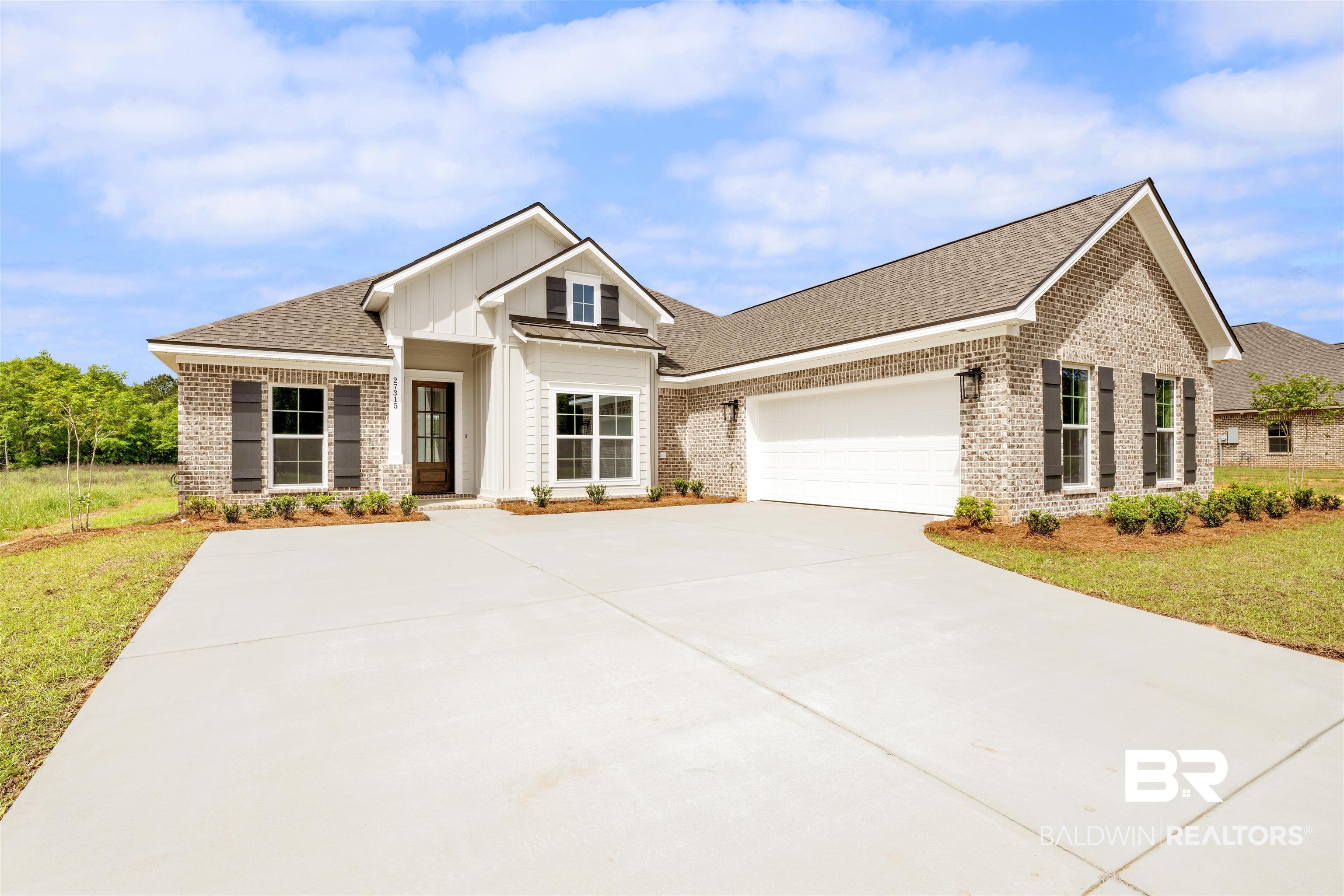 27315 Patch Pl Loop Daphne, AL 36526 - Photo 1 of 43 View of front of home featuring a shingled roof, brick siding, a garage, board and batten siding, and driveway