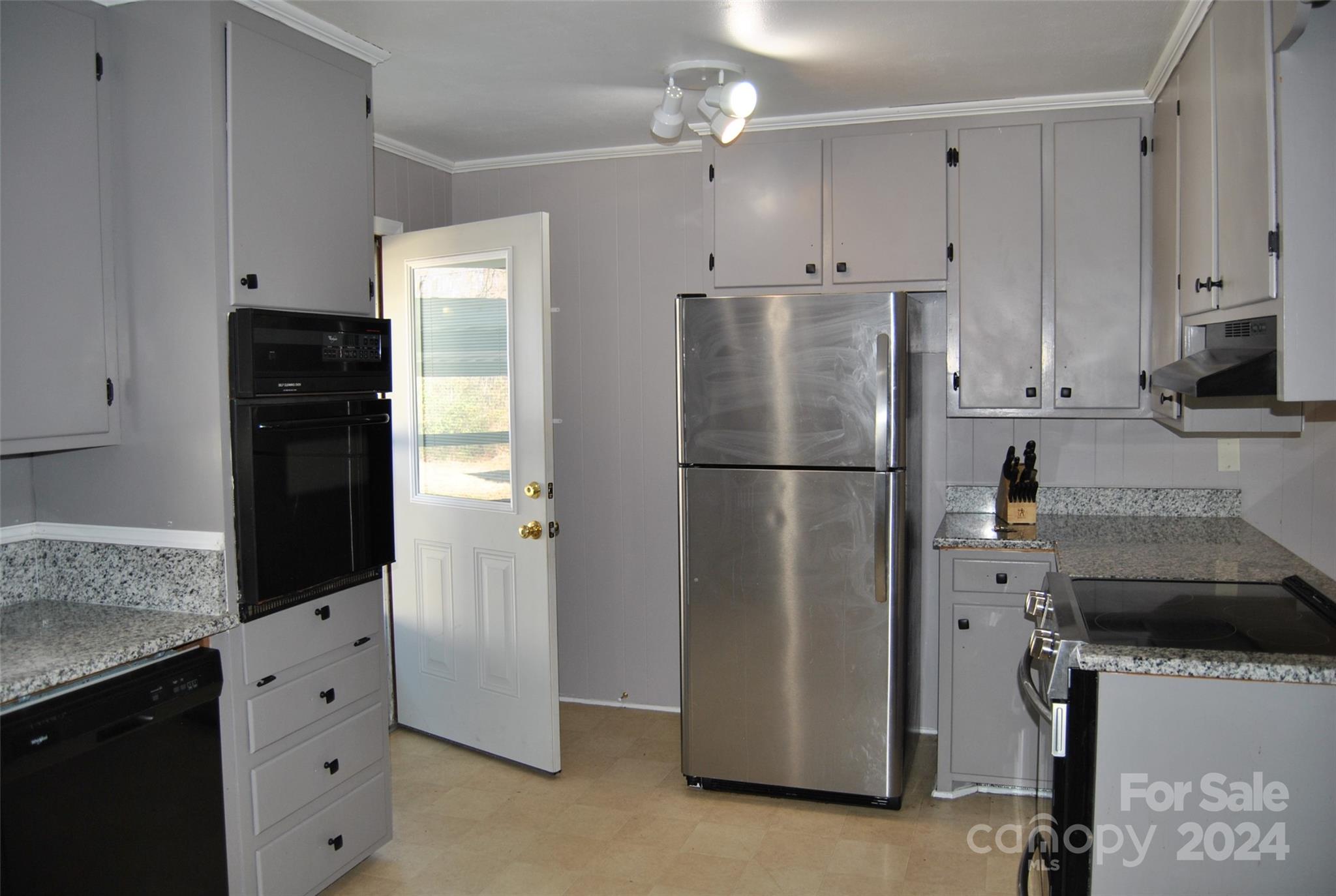 2122 Old Pageland Monroe Road Monroe, NC 28112 - Photo 15 of 24 a kitchen with stainless steel appliances granite countertop a refrigerator a stove a sink and white cabinets