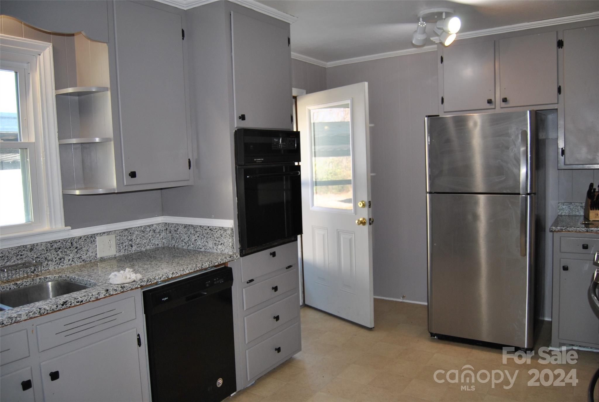 2122 Old Pageland Monroe Road Monroe, NC 28112 - Photo 16 of 24 a kitchen with granite countertop cabinets and refrigerator