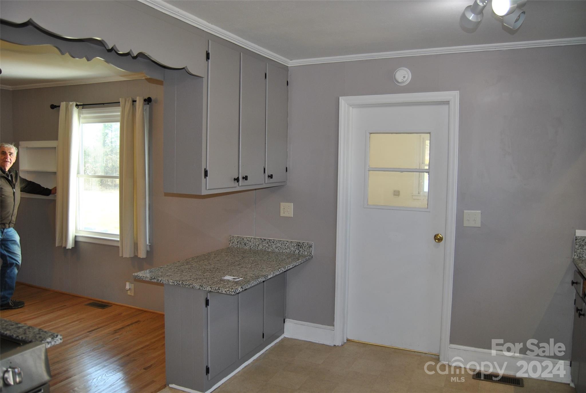 2122 Old Pageland Monroe Road Monroe, NC 28112 - Photo 18 of 24 a kitchen with granite countertop a sink cabinets and a wooden floor