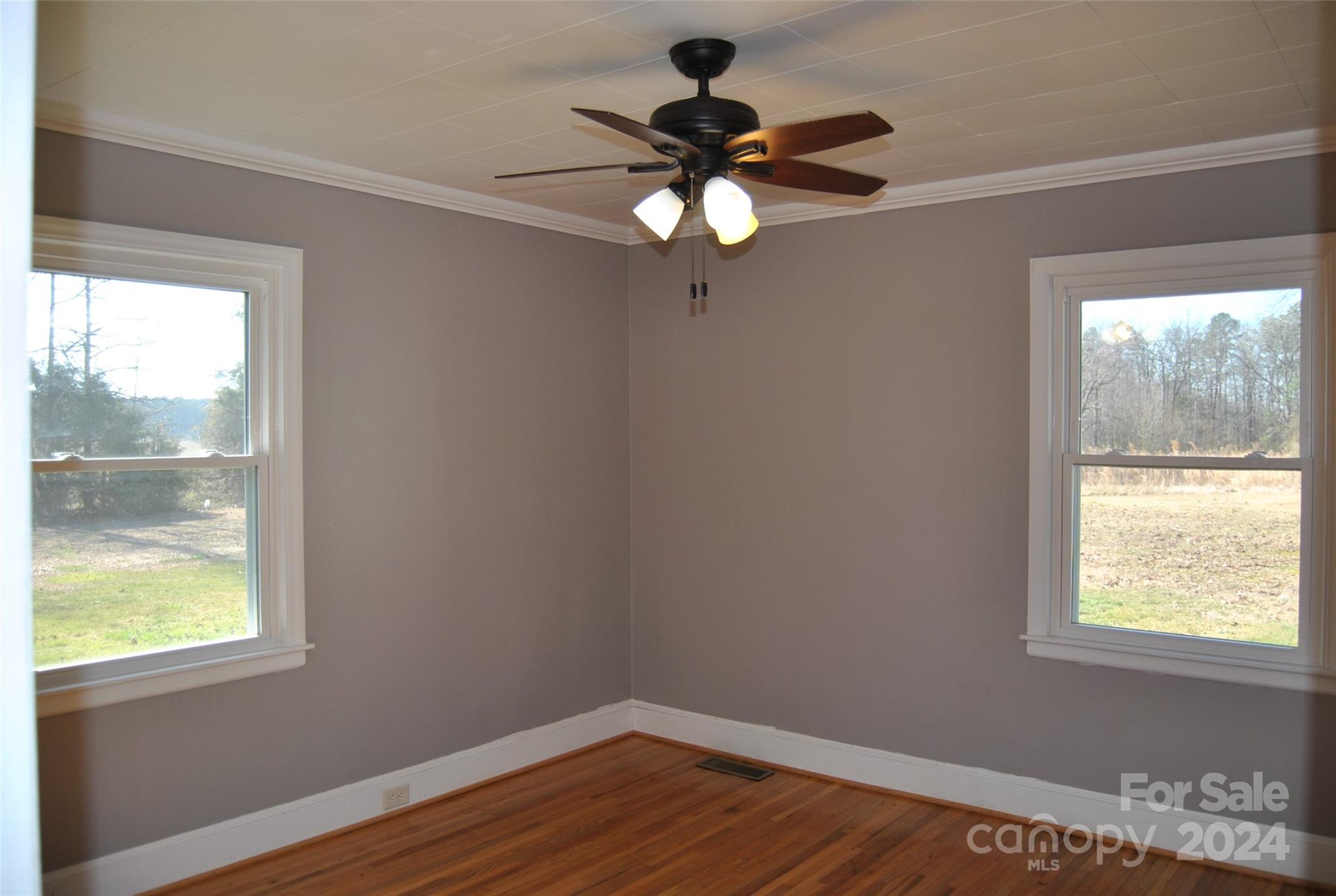 2122 Old Pageland Monroe Road Monroe, NC 28112 - Photo 2 of 24 a view of an empty room with wooden floor and a window