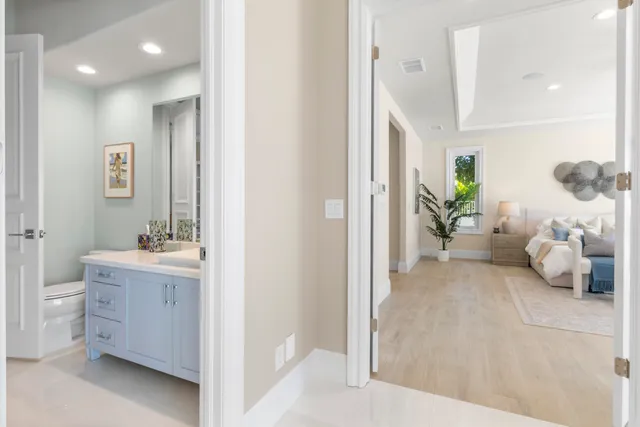 a large bathroom with a double vanity sink a large mirror and a bathtub