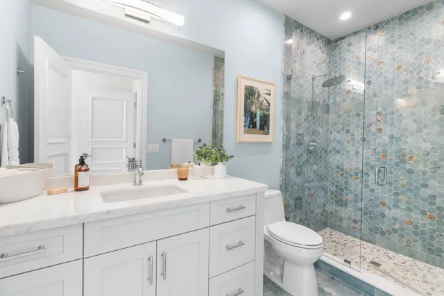 a bathroom with a bathtub sink and mirror
