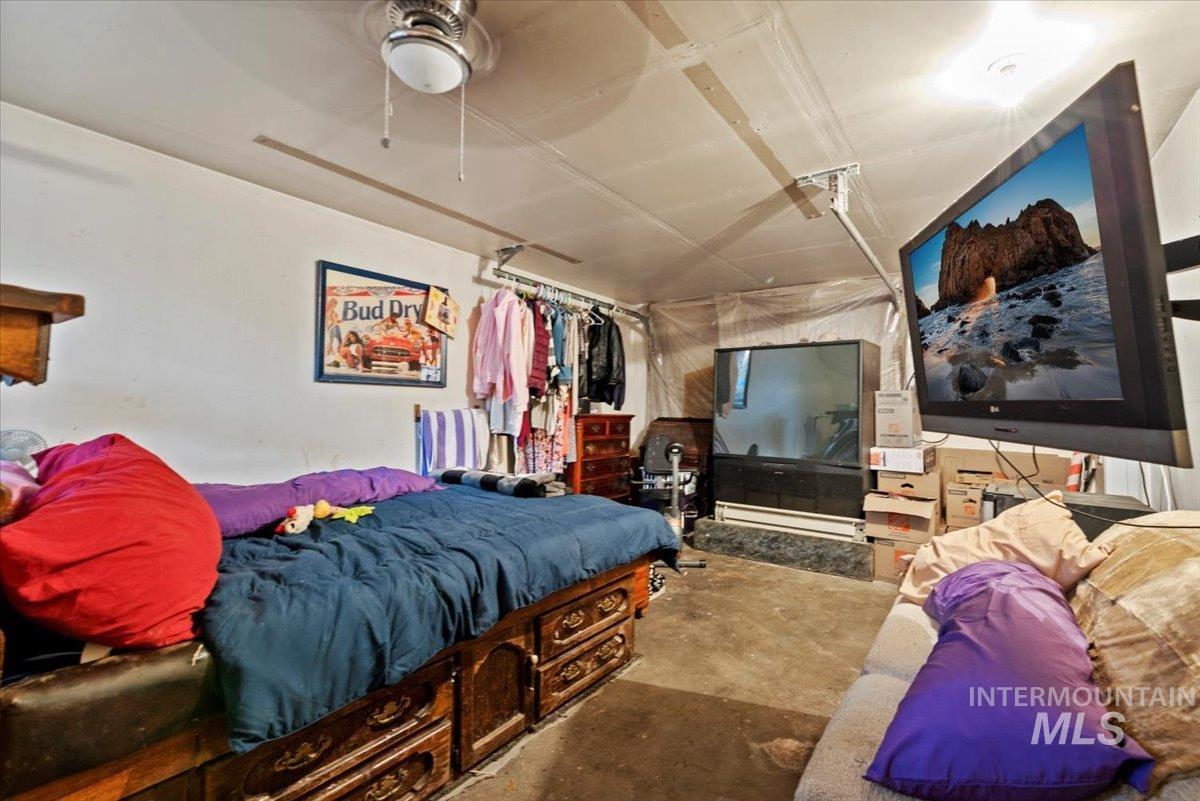 1908 South Atlantic Street Boise, ID 83705 - Photo 11 of 18 Bedroom featuring a ceiling fan, concrete flooring, and a baseboard radiator