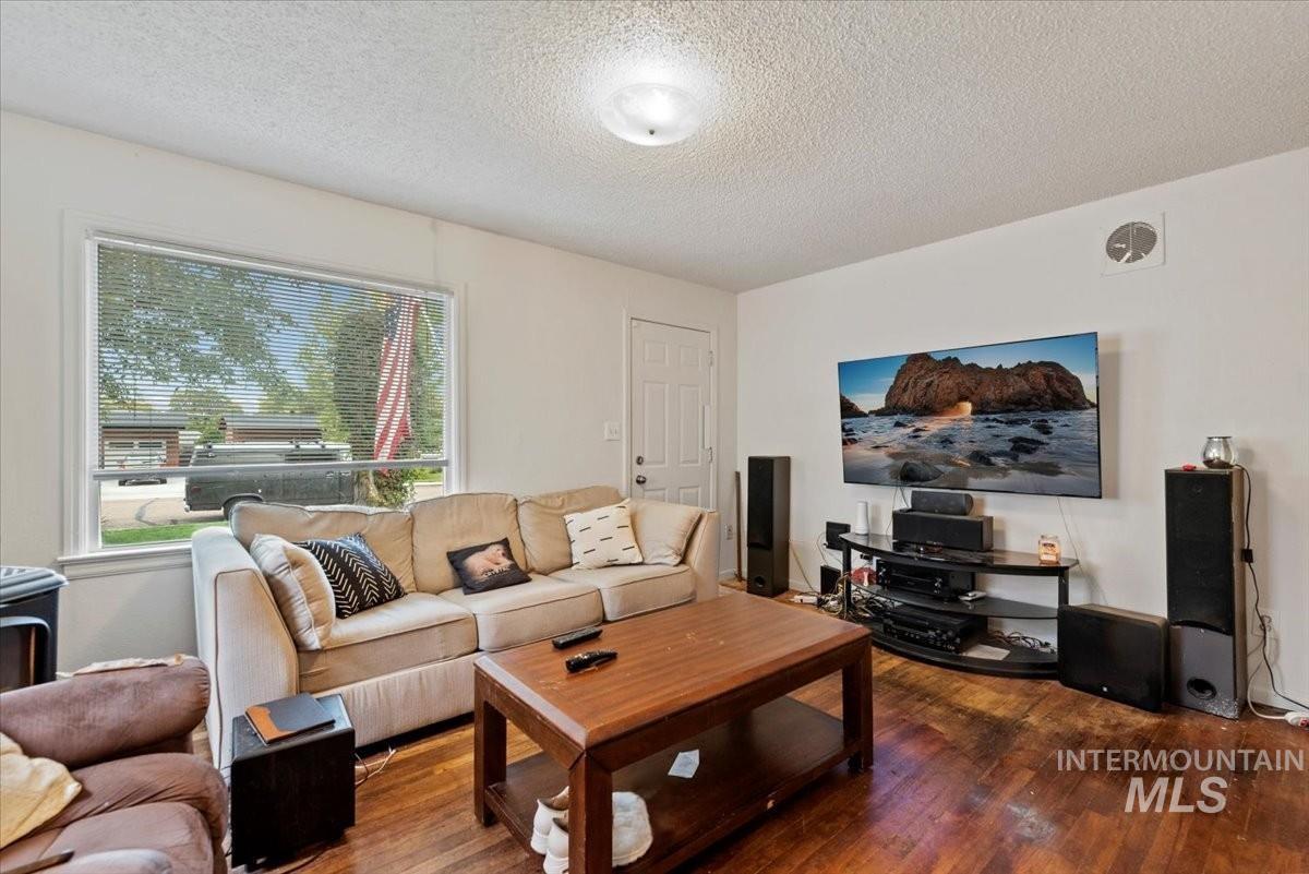 1908 South Atlantic Street Boise, ID 83705 - Photo 5 of 18 Living room with a textured ceiling and dark wood-type flooring