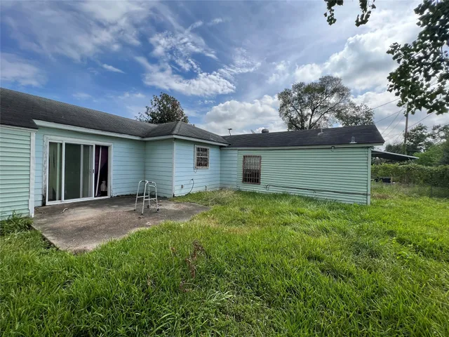 a view of backyard of house with green space