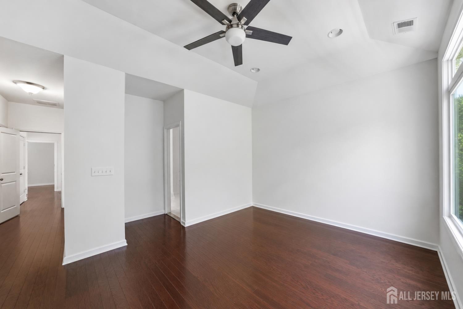 133 Savoth Lane Colonia, NJ 07067 - Photo 16 of 21 an empty room with wooden floor closet and fan