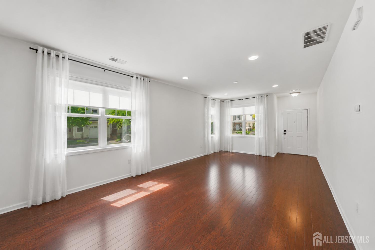 133 Savoth Lane Colonia, NJ 07067 - Photo 19 of 21 a view of an empty room with wooden floor and a window