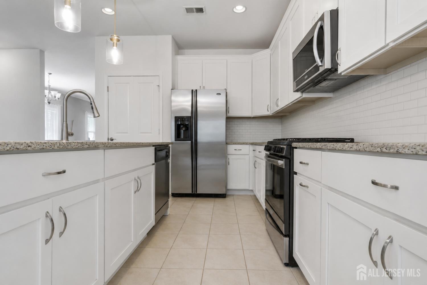133 Savoth Lane Colonia, NJ 07067 - Photo 3 of 21 a kitchen with stainless steel appliances granite countertop a sink and a refrigerator