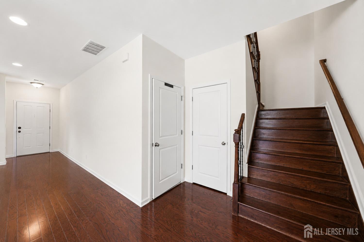 133 Savoth Lane Colonia, NJ 07067 - Photo 8 of 21 a view of a hallway with wooden floor and entryway