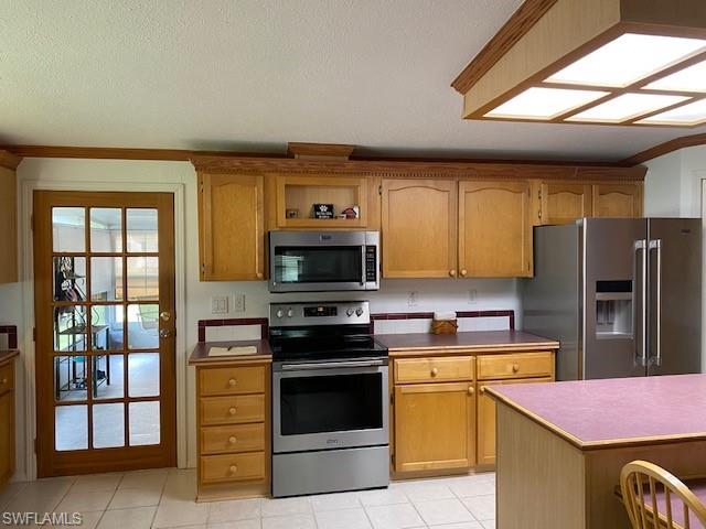 298 Riverwood Road Naples, FL 34114 - Photo 19 of 39 a kitchen with stainless steel appliances a stove sink and microwave