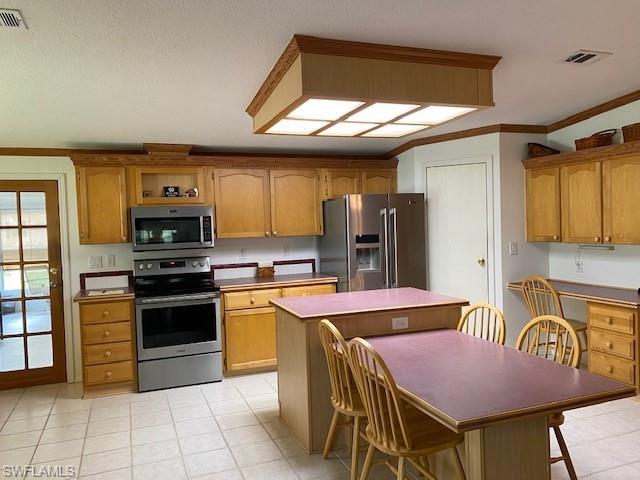 298 Riverwood Road Naples, FL 34114 - Photo 20 of 39 a kitchen with stainless steel appliances granite countertop a stove top oven a sink a dining table and chairs