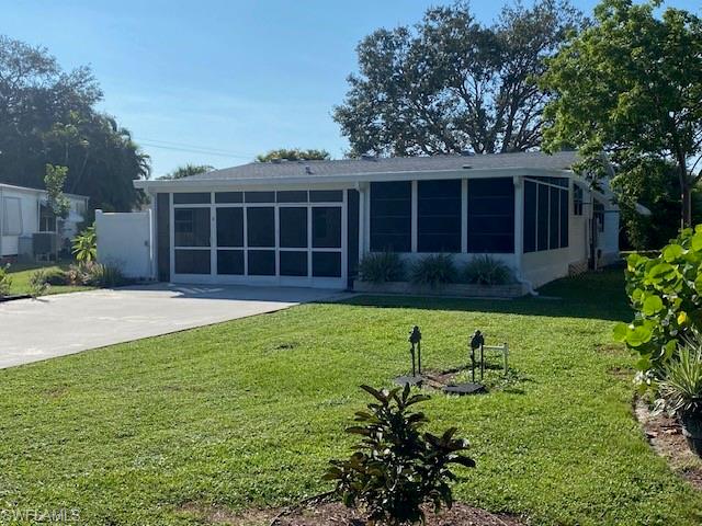 298 Riverwood Road Naples, FL 34114 - Photo 2 of 39 a view of a house with a yard and potted plants