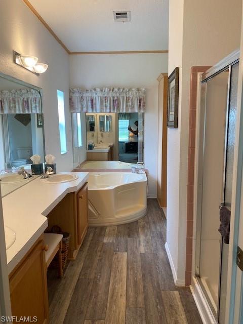 298 Riverwood Road Naples, FL 34114 - Photo 25 of 39 a large spacious bathroom with a double vanity sink a mirror and a bathtub