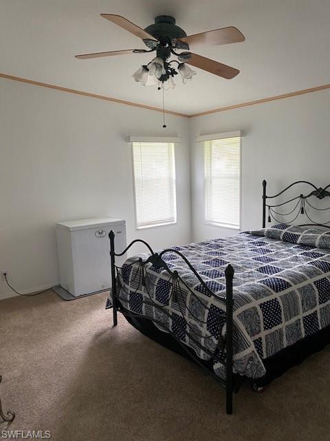 298 Riverwood Road Naples, FL 34114 - Photo 28 of 39 a bedroom with a bed and a chandelier