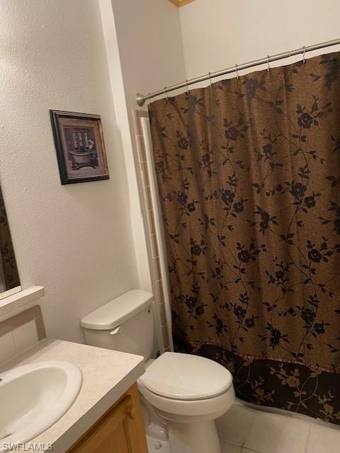 298 Riverwood Road Naples, FL 34114 - Photo 30 of 39 a white toilet sitting next to a shower curtain