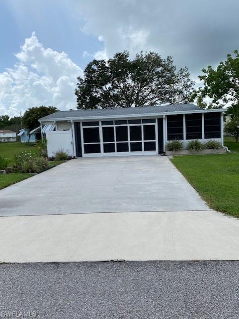 298 Riverwood Road Naples, FL 34114 - Photo 3 of 39 front view of a house with a yard