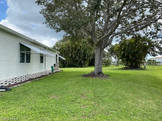 298 Riverwood Road Naples, FL 34114 - Photo 38 of 39 a view of a backyard with large trees