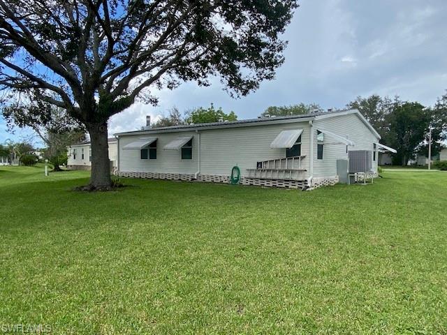 298 Riverwood Road Naples, FL 34114 - Photo 39 of 39 a front view of house with yard and green space