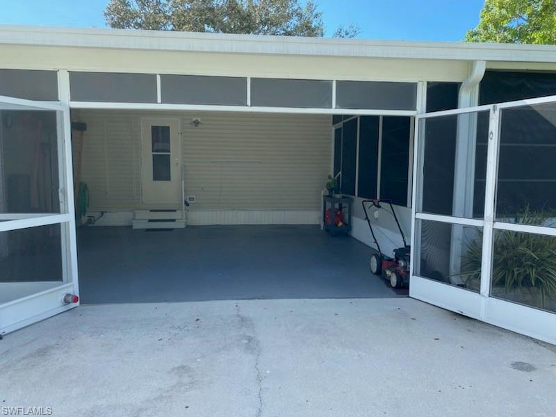 298 Riverwood Road Naples, FL 34114 - Photo 6 of 39 a view of an empty room with wooden floor and windows