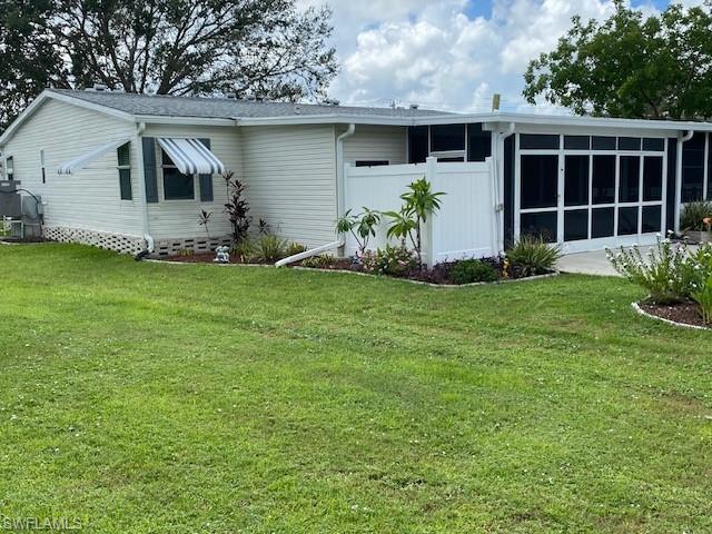298 Riverwood Road Naples, FL 34114 - Photo 8 of 39 a front view of a house with a garden and yard