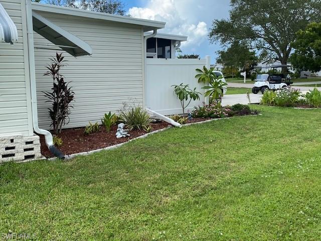 298 Riverwood Road Naples, FL 34114 - Photo 9 of 39 a front view of a house with garden