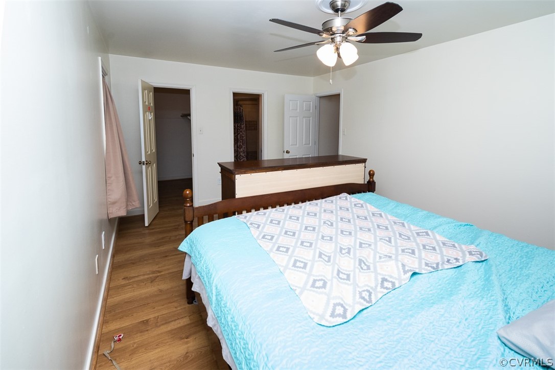 7110 Barkbridge Road Chesterfield, VA 23832 - Photo 19 of 34 a bedroom with a bed and a chandelier