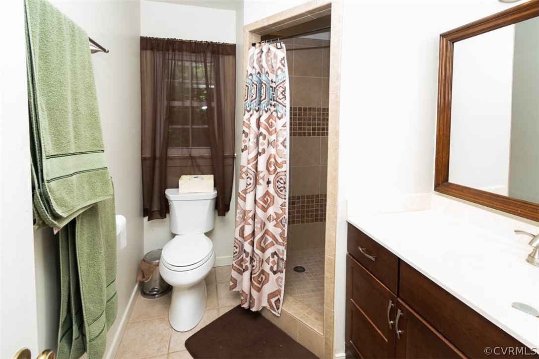 7110 Barkbridge Road Chesterfield, VA 23832 - Photo 20 of 34 a bathroom with a toilet a sink and shower