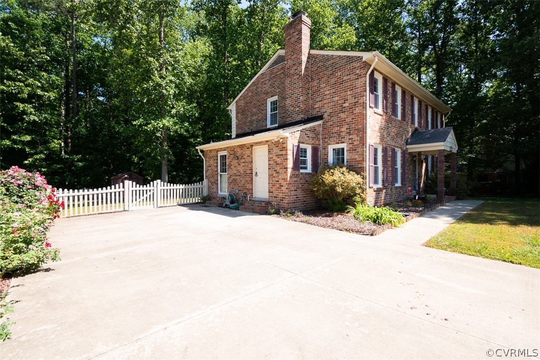 7110 Barkbridge Road Chesterfield, VA 23832 - Photo 4 of 34 a front view of a house with a yard and garage