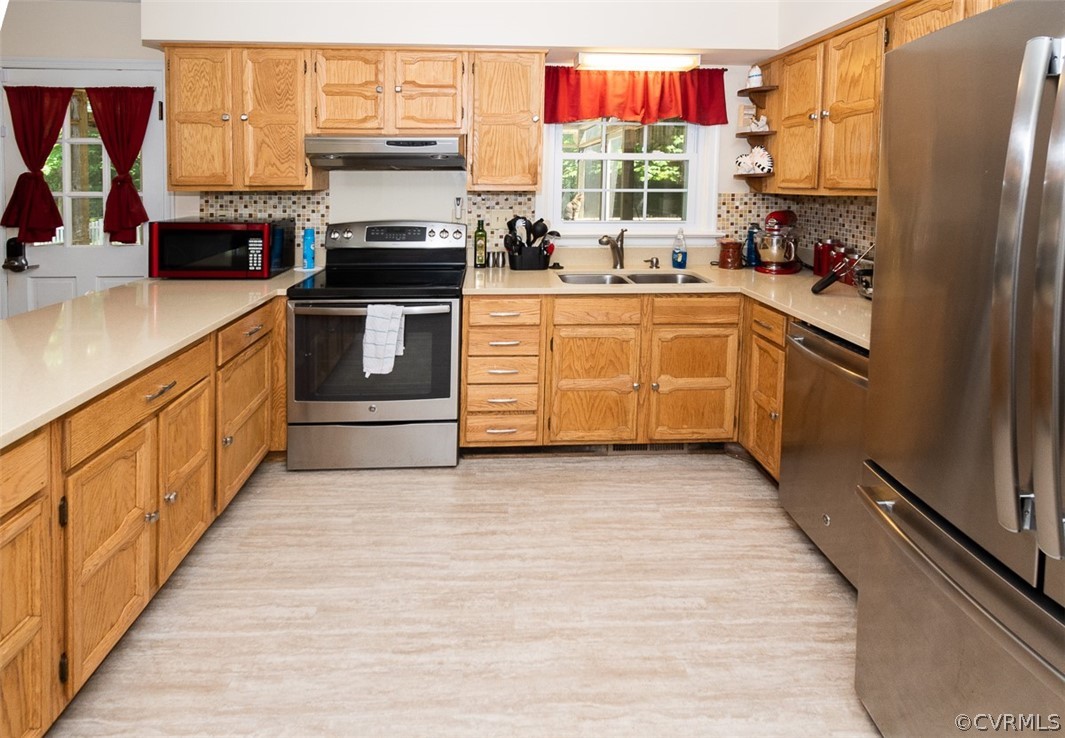 7110 Barkbridge Road Chesterfield, VA 23832 - Photo 7 of 34 a kitchen with stainless steel appliances granite countertop a stove a sink and a refrigerator