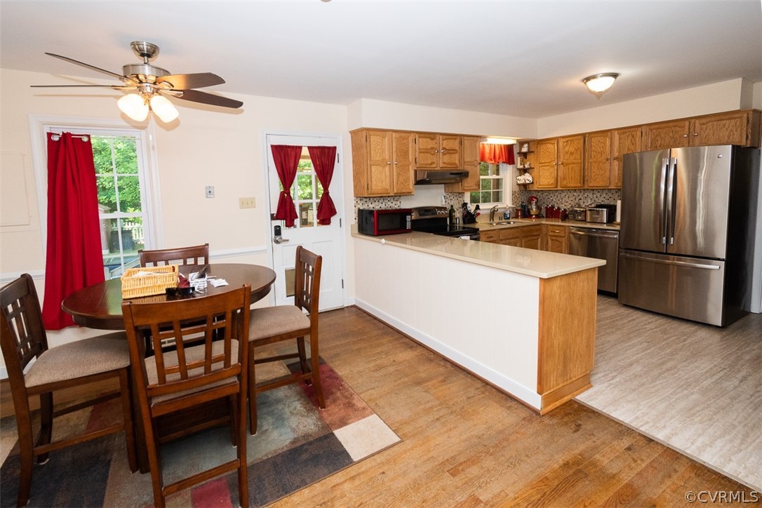 7110 Barkbridge Road Chesterfield, VA 23832 - Photo 9 of 34 a kitchen with stainless steel appliances granite countertop a dining table chairs stove refrigerator and microwave