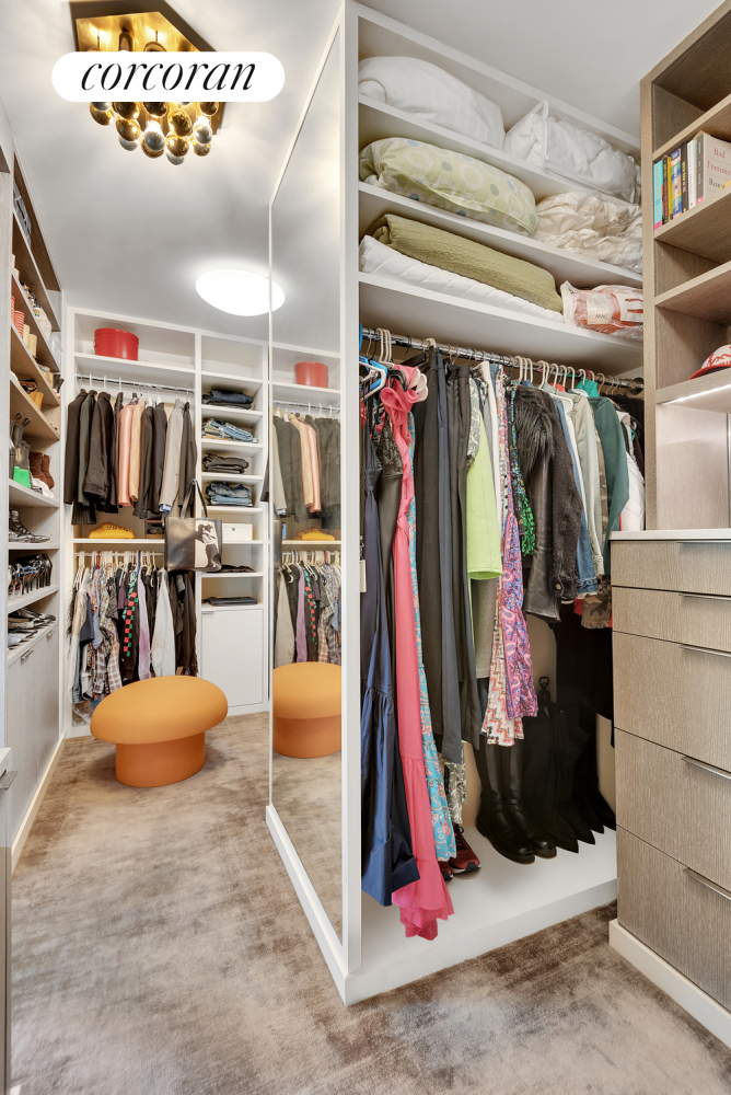 1220 Park Avenue, Unit 13D Manhattan, NY 10128 - Photo 11 of 19 a view of walk in closet with clothes and shoes