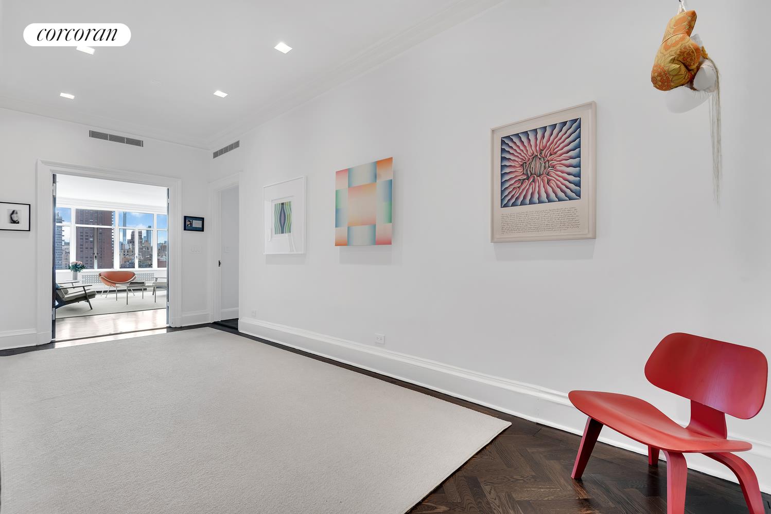 1220 Park Avenue, Unit 13D Manhattan, NY 10128 - Photo 14 of 19 a view of an empty room with furniture and windows