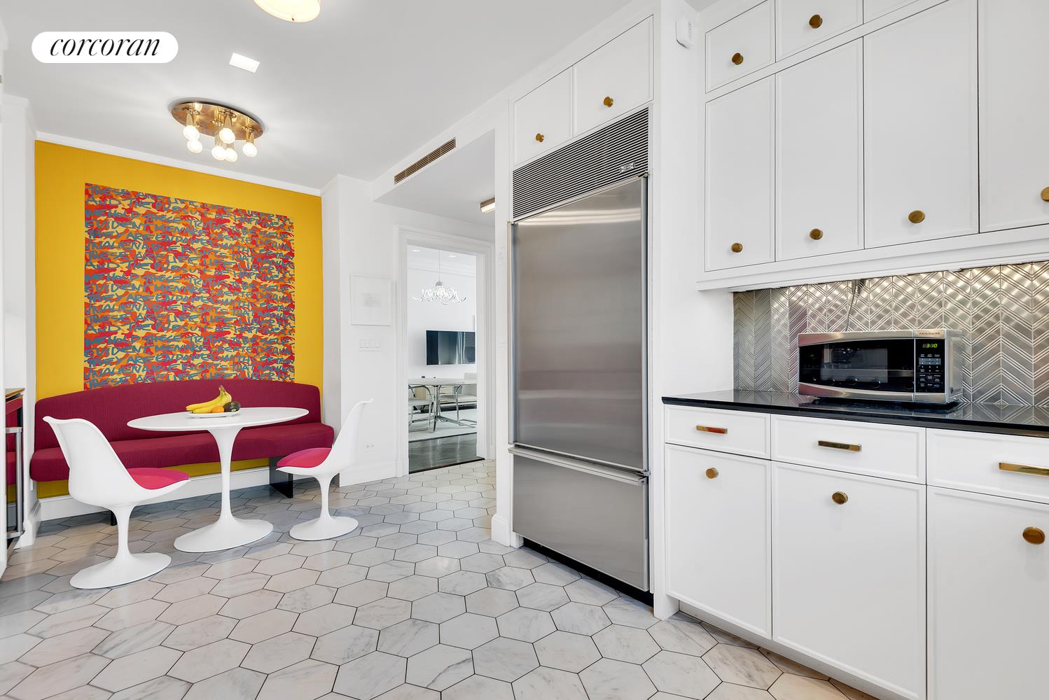1220 Park Avenue, Unit 13D Manhattan, NY 10128 - Photo 8 of 19 a kitchen with cabinets and chairs