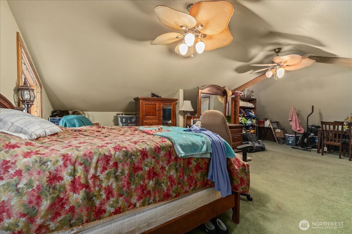 19095 Gill Creek Road Leavenworth, WA 98826 - Photo 13 of 30 a bedroom with a bed a chandelier and closet