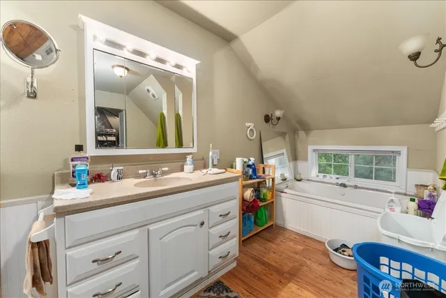 a bathroom with a sink mirror and a bathtub